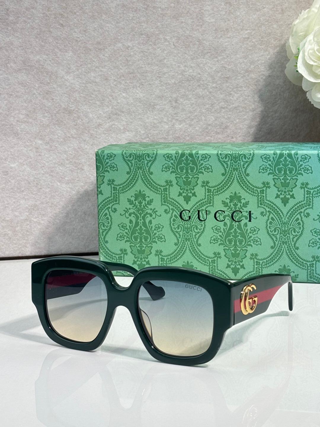 Gucci square sunglasses with dark green frame and light gradient lenses