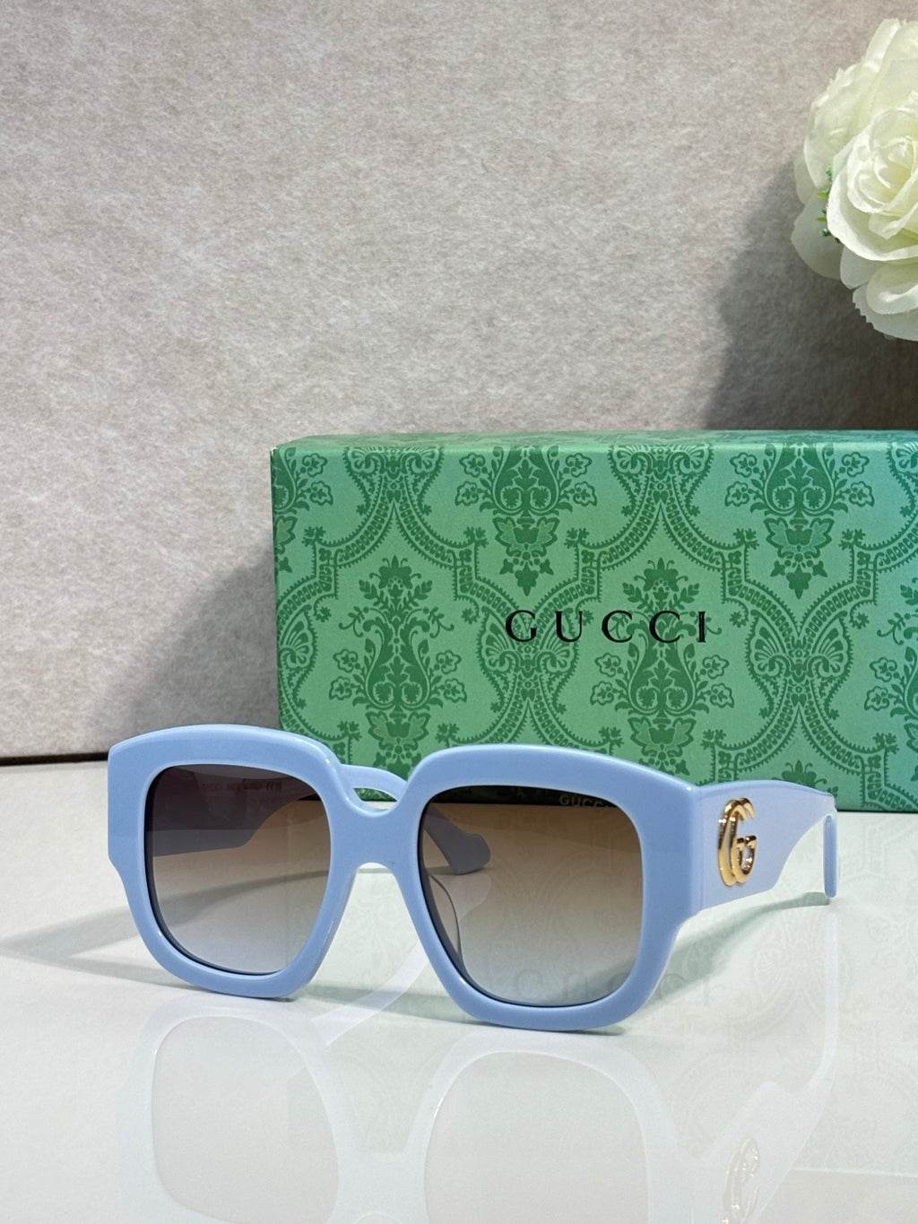 Gucci square sunglasses with light blue frame and dark lenses