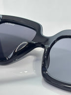 Gucci sunglasses close-up showing black frame and dark lens