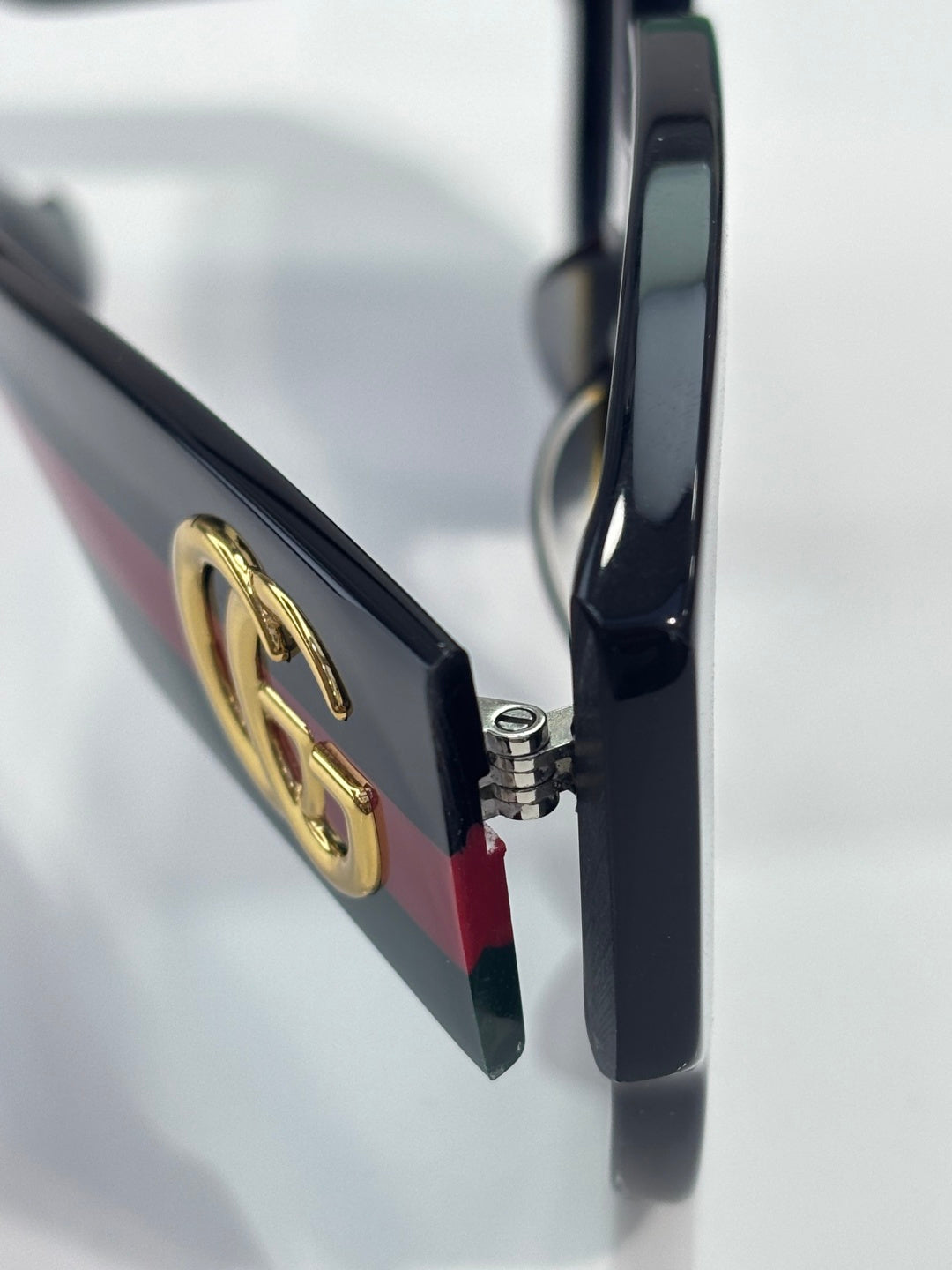 Gucci sunglasses close-up of hinge and gold double-G logo on temple