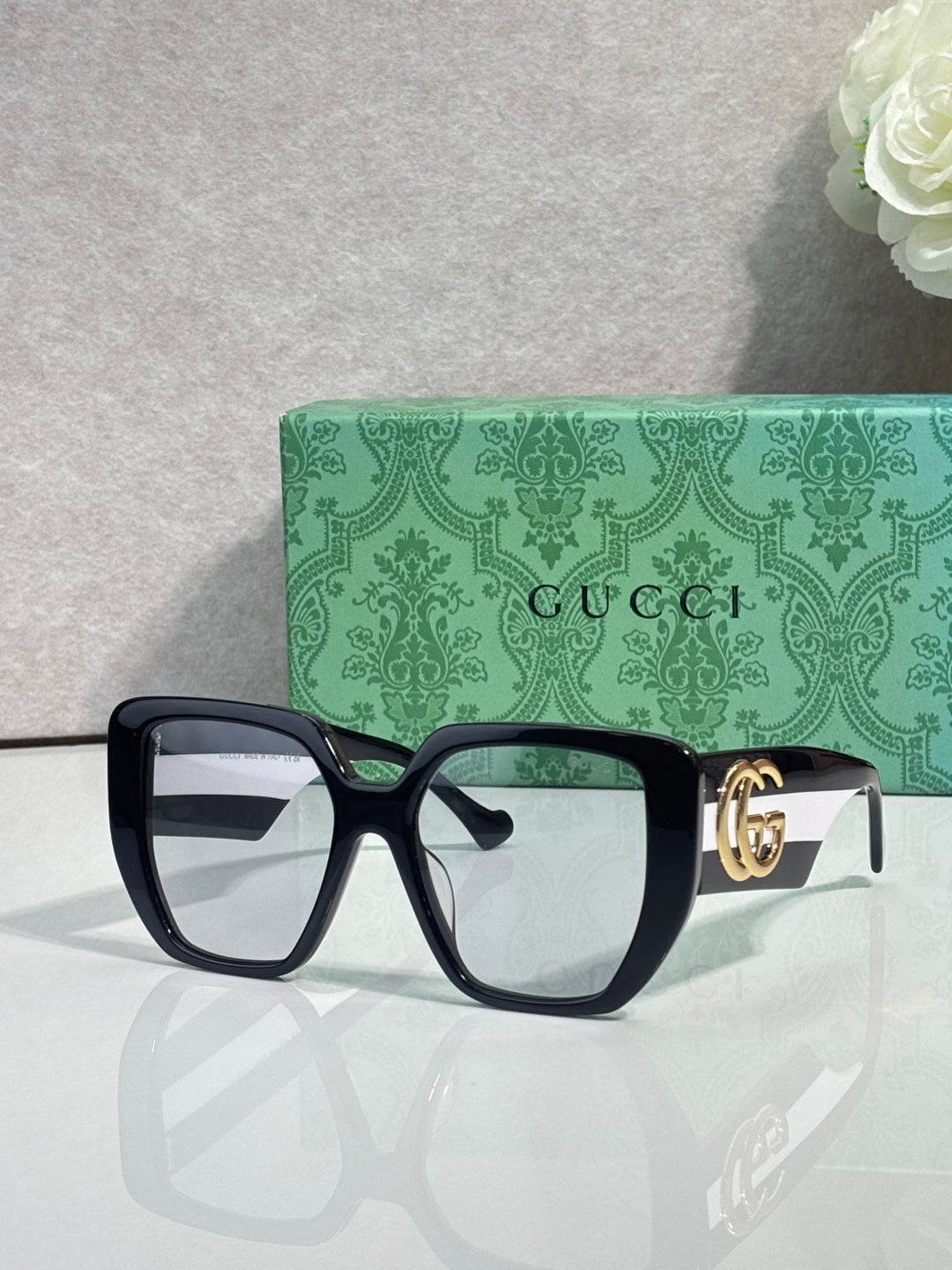 Gucci dark green square sunglasses with gold logo on temples and clear lenses