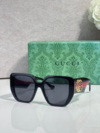Gucci dark green square sunglasses with gold logo temple detail and dark lenses