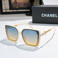 Beige square sunglasses with blue lenses and gold chain temple details