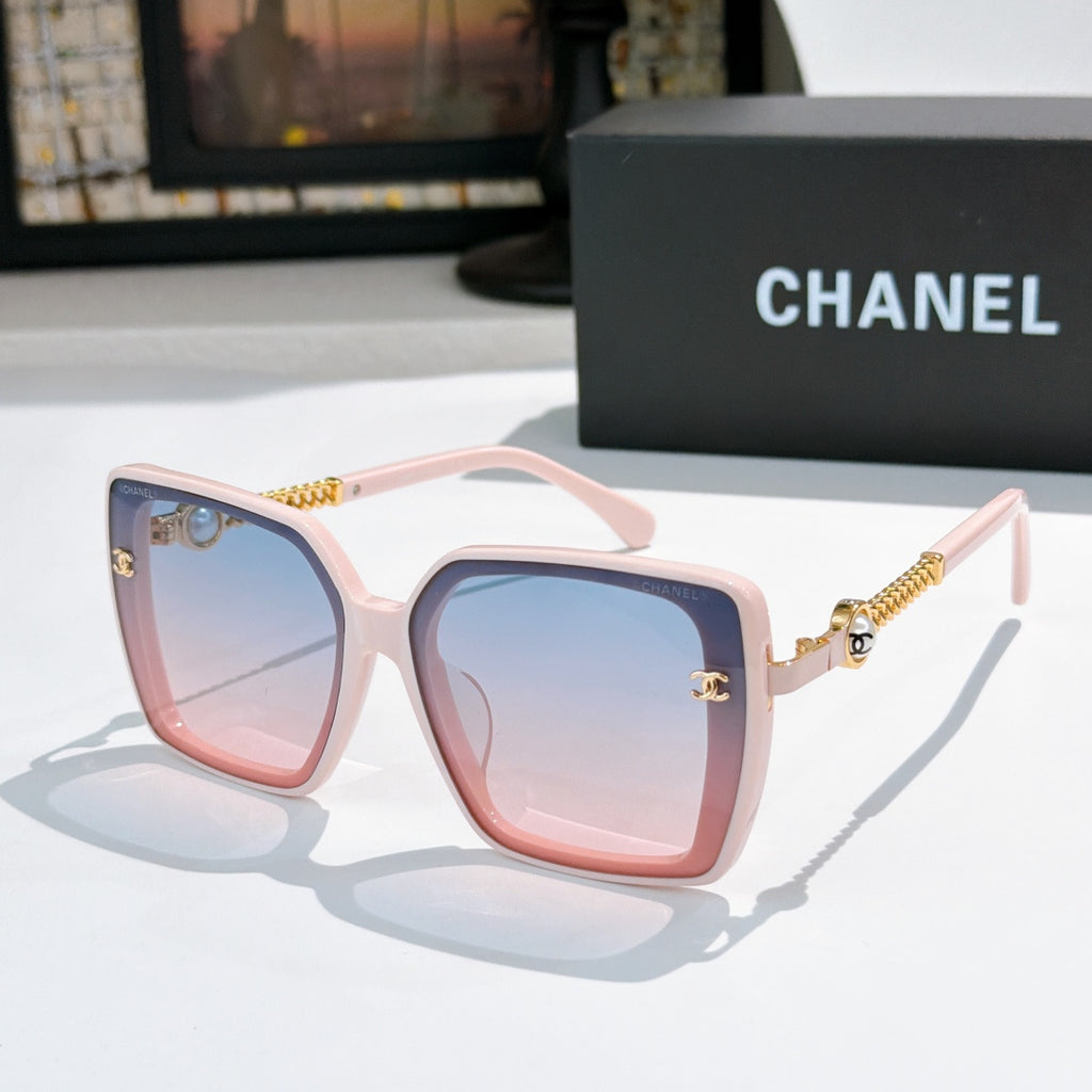 Light pink square sunglasses with blue lenses and gold chain temple details