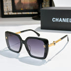 Black square sunglasses with purple lenses and gold chain temple details