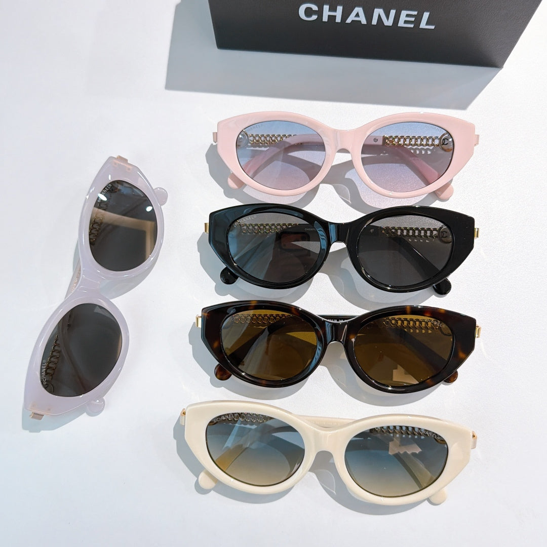Set of four sunglasses on display: pink, black, brown, and white frames.