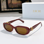 Sunglasses with maroon/red frames and warm brown tinted lenses