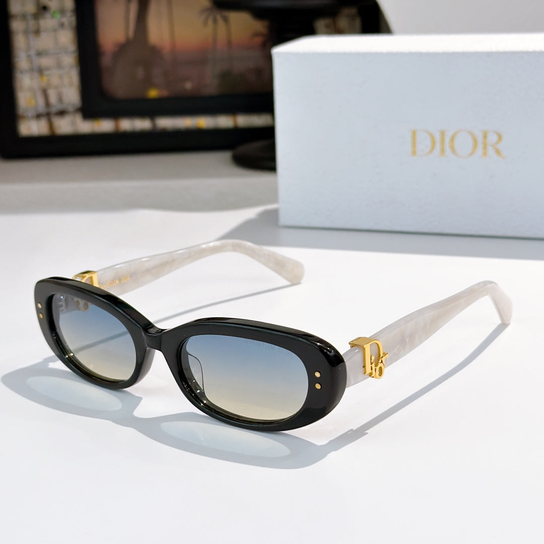 Sunglasses with clear frames, dark lenses, and gold-tone detail