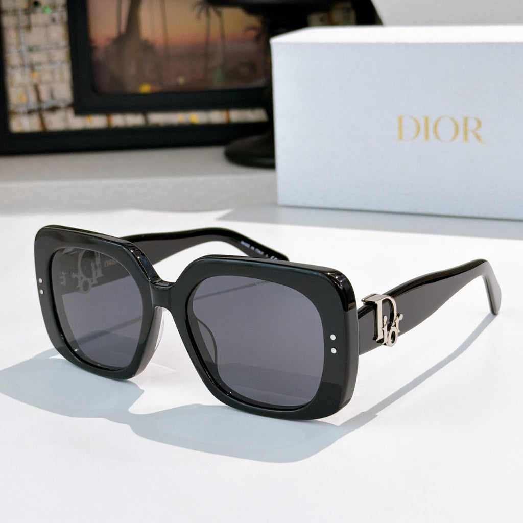 Black sunglasses with dark square lenses and gold logo hinge detail