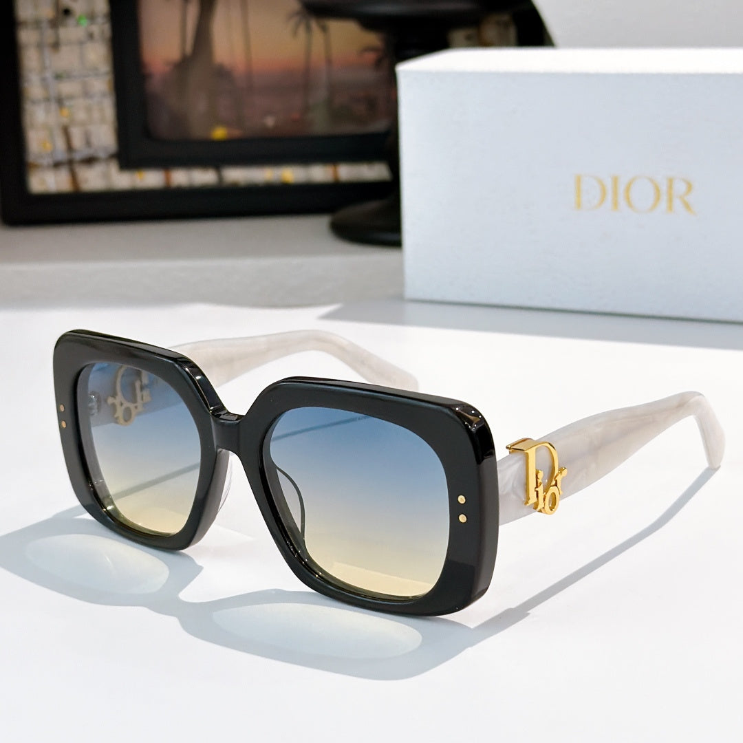 Black sunglasses with blue-tinted square lenses and gold logo hinge detail