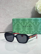 Gucci square sunglasses with dark frame and rounded corners, dark lenses, gold logo temples
