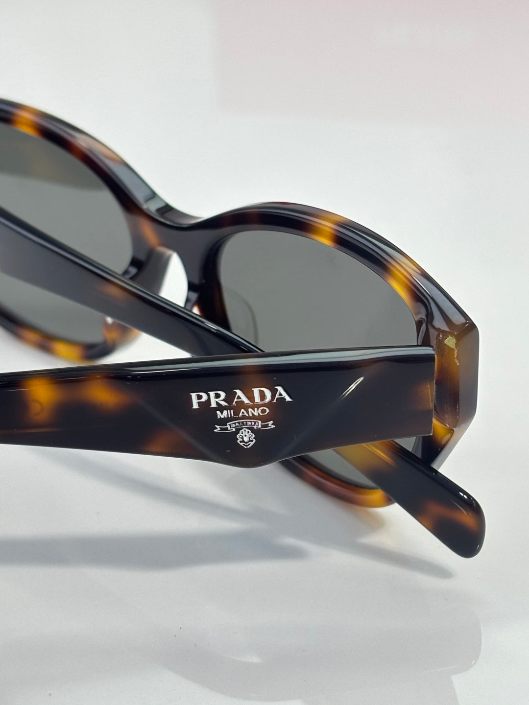 Prada sunglasses bridge with logo and dark lenses