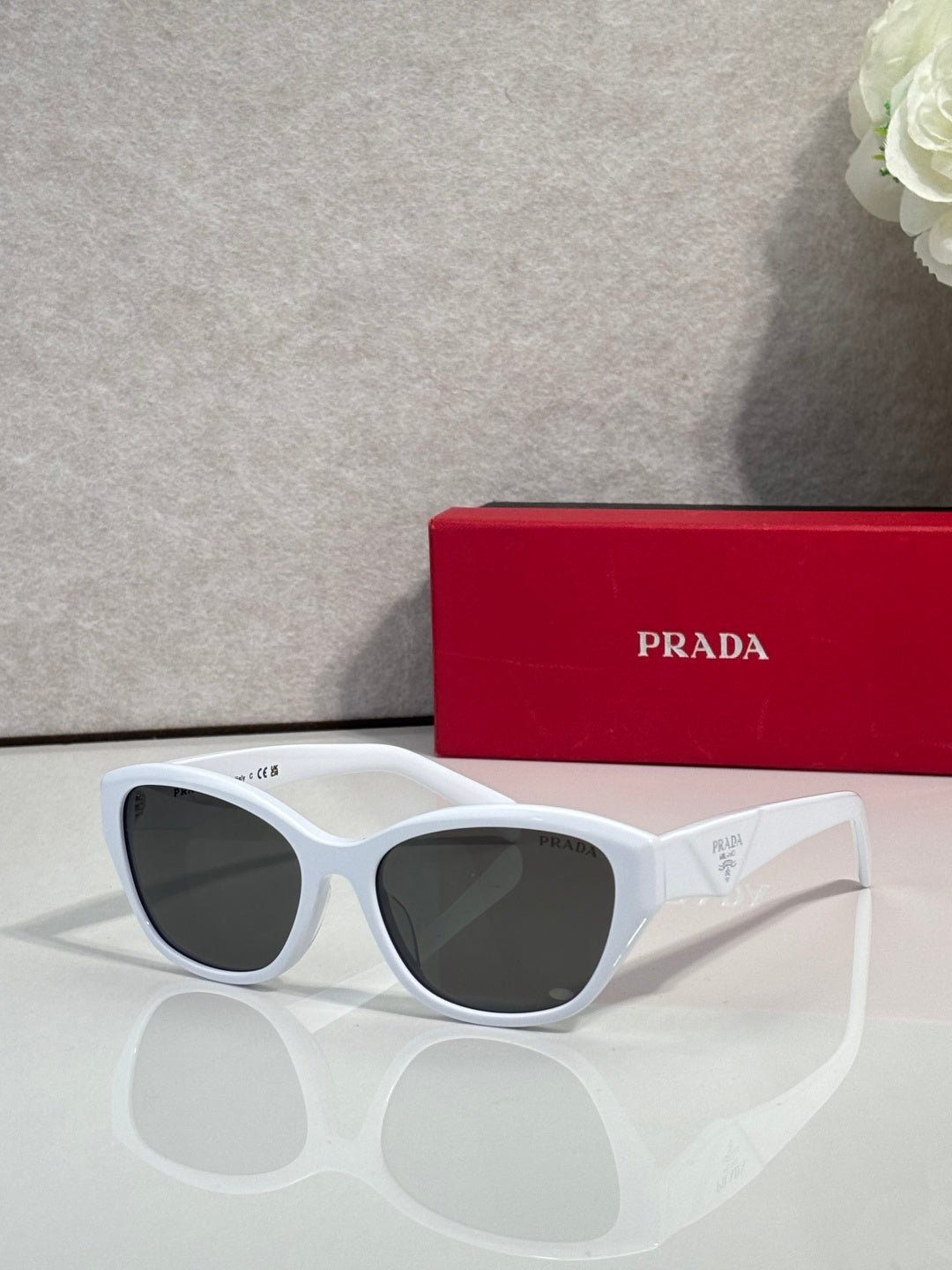 White cat-eye sunglasses with dark lenses