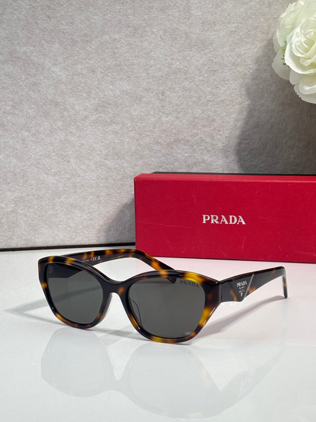 Prada sunglasses with tortoiseshell frames and dark lenses