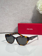 Prada sunglasses with tortoiseshell frames and dark lenses