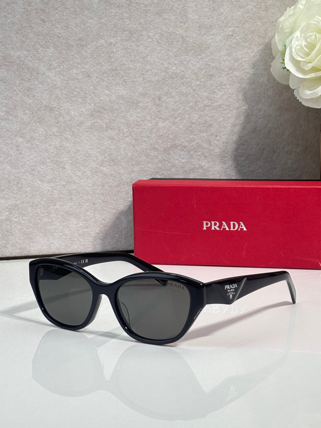 Prada sunglasses with black frames and dark lenses