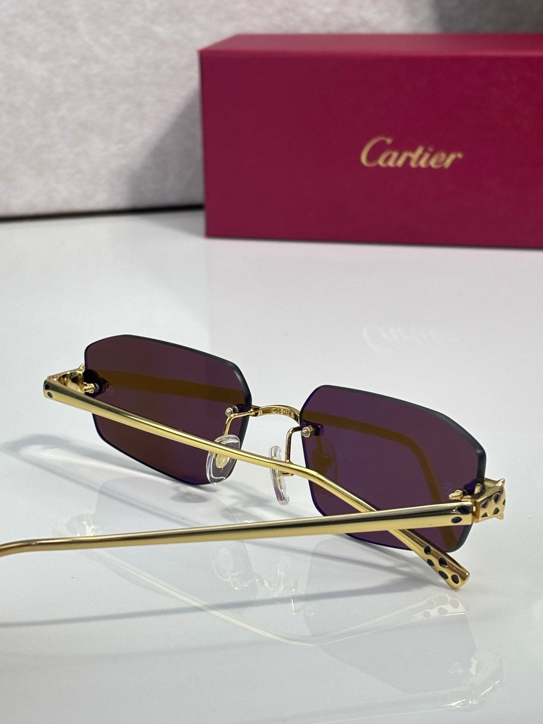 Cartier gold-tone sunglasses with dark maroon lenses