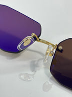 Cartier gold-tone sunglasses close-up with purple-tinted lens