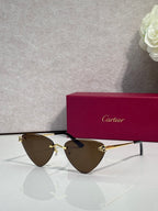 Cartier gold metal eyeglasses with black temples, brown-tinted lenses, cat-eye style