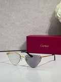 Cartier gold metal eyeglasses with black temples, tinted clear lenses, cat-eye style