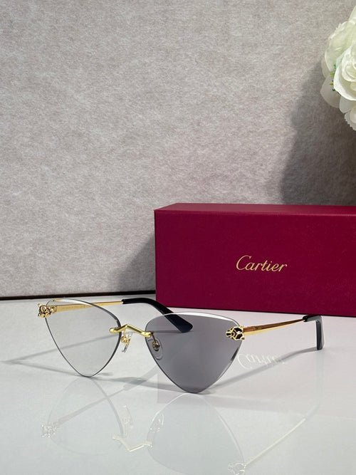 Cartier gold metal eyeglasses with black temples, tinted clear lenses, cat-eye style
