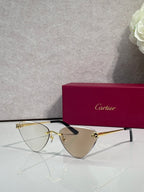 Cartier gold metal eyeglasses with black temples, reflective tinted lenses, cat-eye style