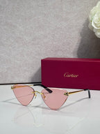 Cartier gold metal eyeglasses with black temples, pink-tinted lenses, cat-eye style