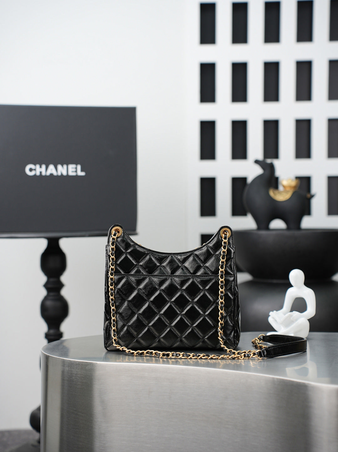 Quilted Chanel bag with gold chain shoulder strap, black quilted diamond pattern