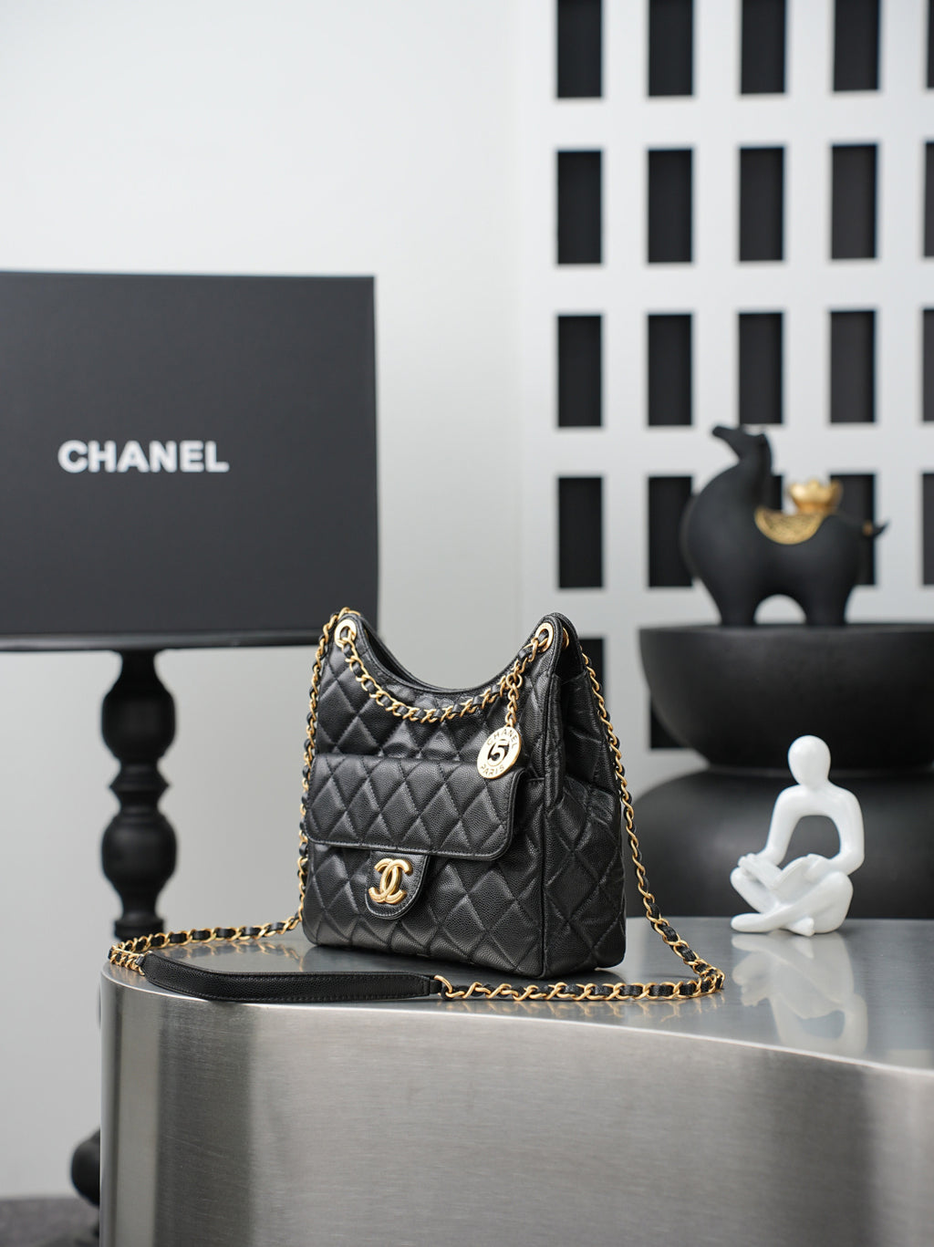 Chanel quilted shoulder bag with gold chain, CC plaque, and pocket front