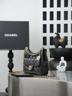 Chanel quilted shoulder bag with gold chain, CC plaque, and pocket front