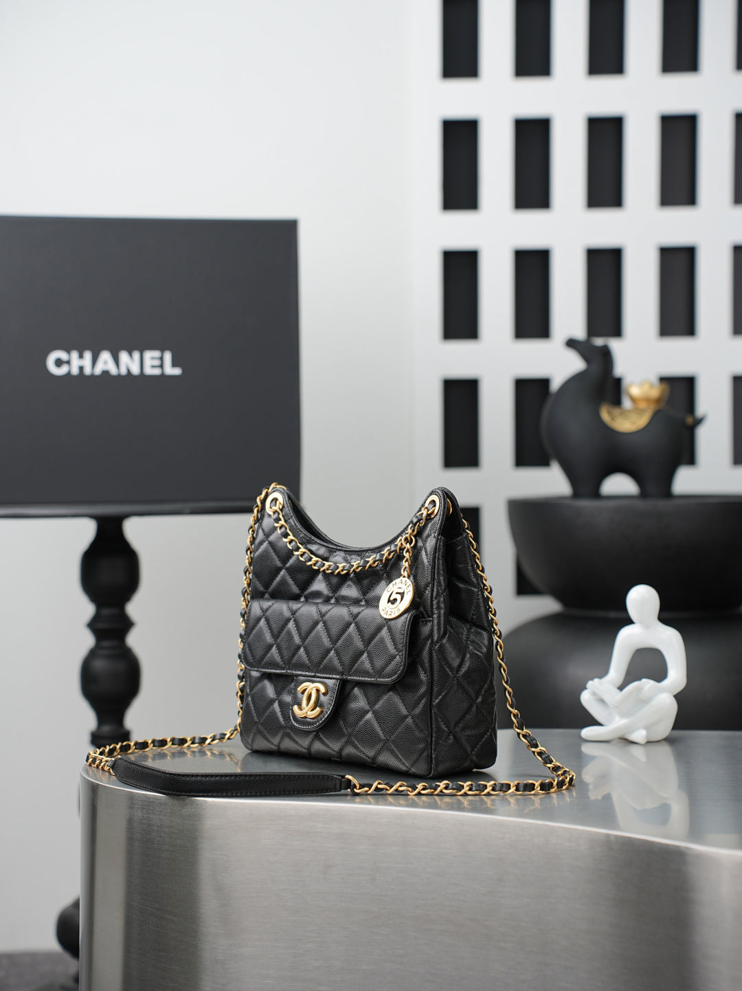 Chanel quilted shoulder bag with gold chain, CC plaque, and pocket front