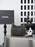 Chanel quilted shoulder bag with gold chain strap and dark quilted front