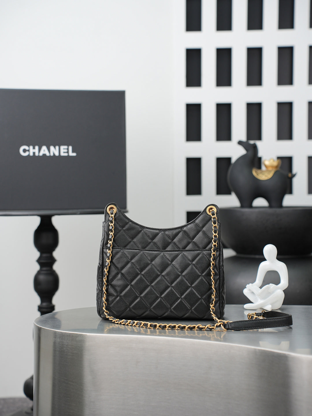 Chanel quilted shoulder bag with gold chain strap and dark quilted front