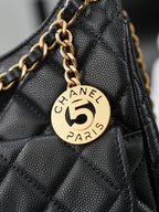 Chanel "5" charm on gold chain attached to dark quilted bag