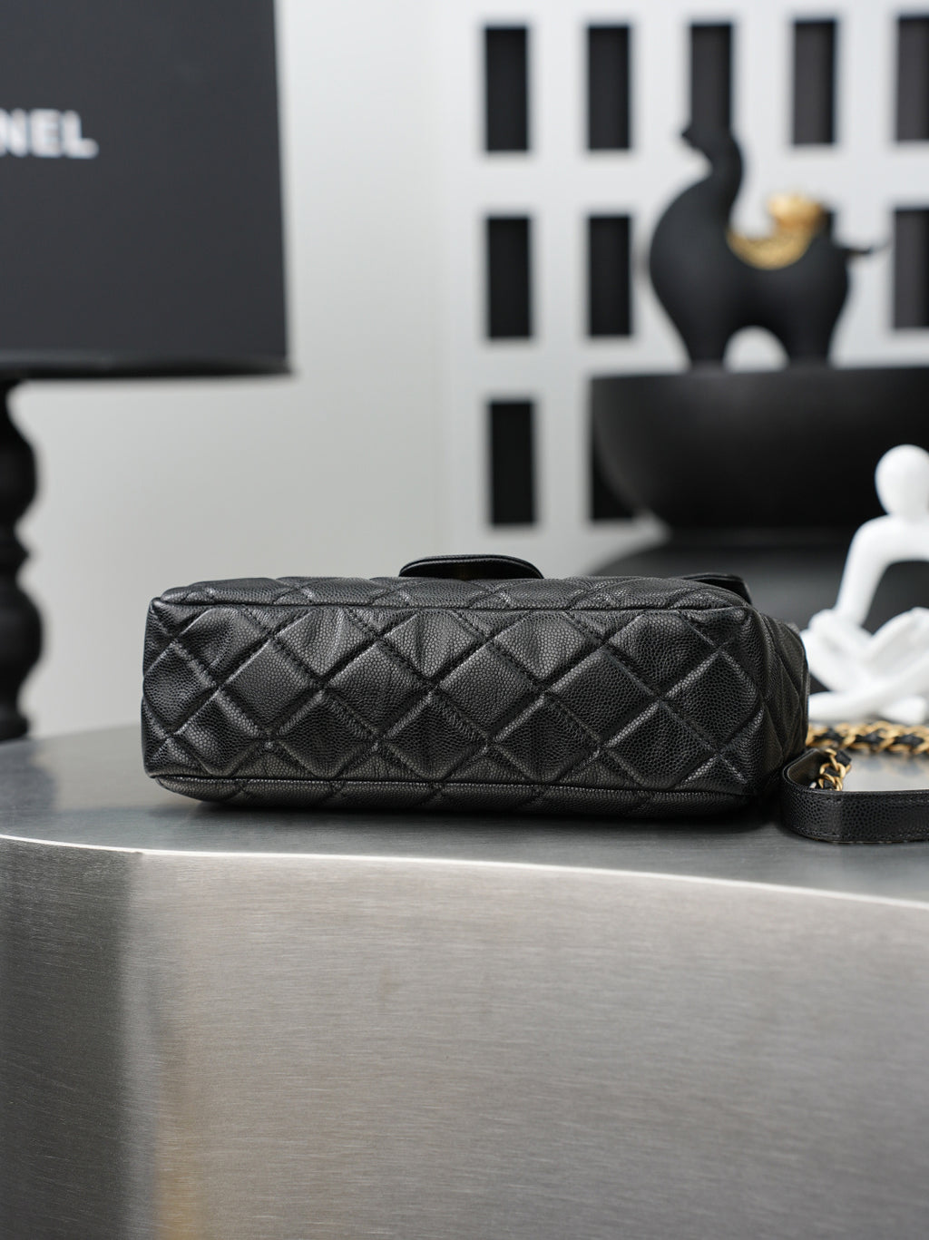 Chanel quilted bag with chain strap, front flap, and dark leather exterior