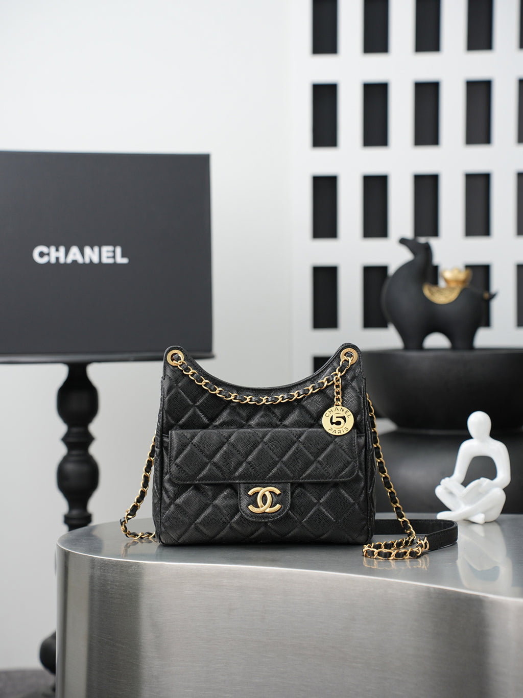 Chanel quilted shoulder bag in dark color with gold chain strap and CC logo front