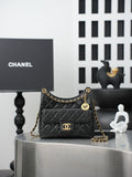 Chanel quilted shoulder bag in dark color with gold chain strap and CC logo front