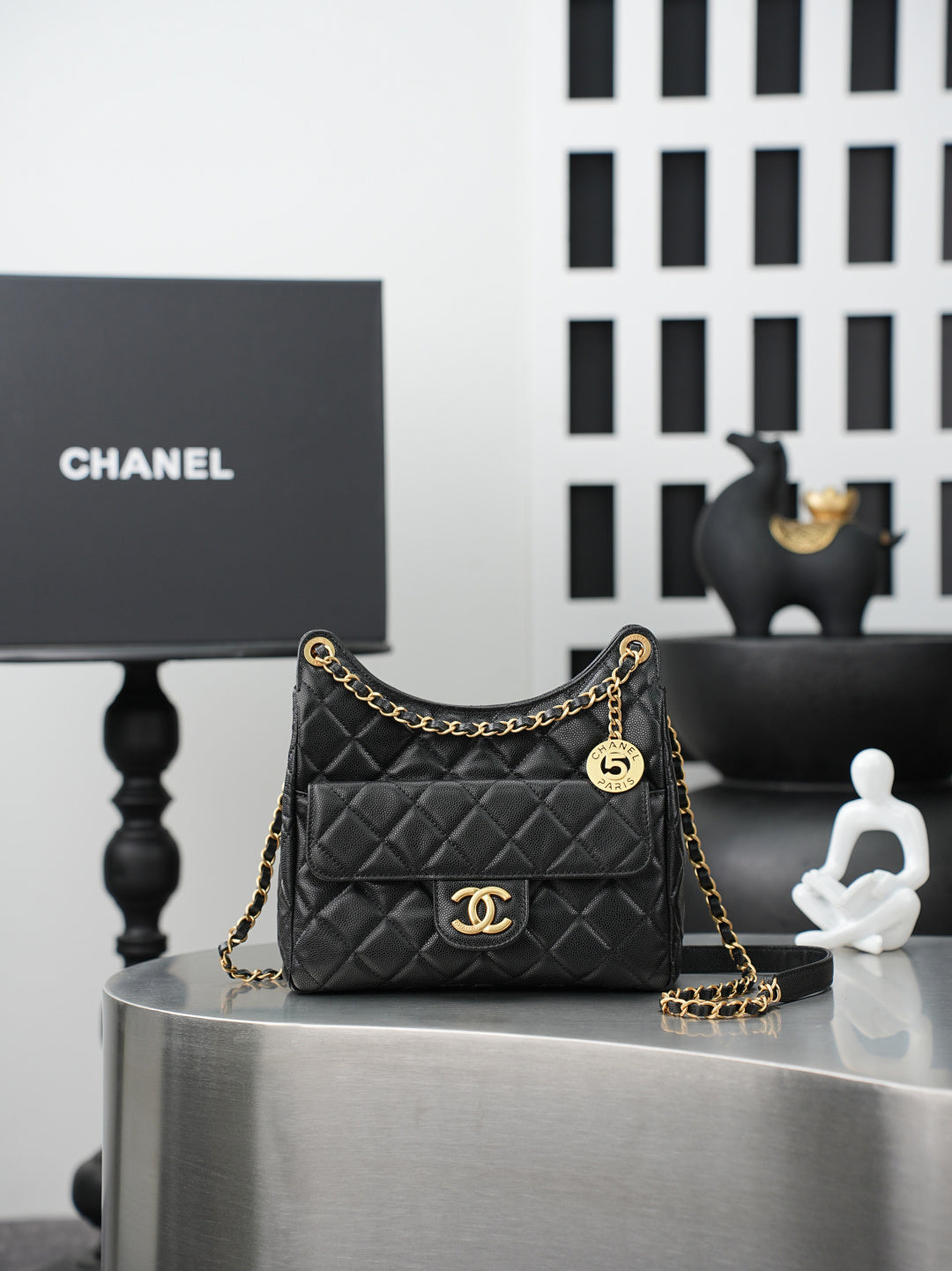 Chanel quilted shoulder bag in dark color with gold chain strap and CC logo front