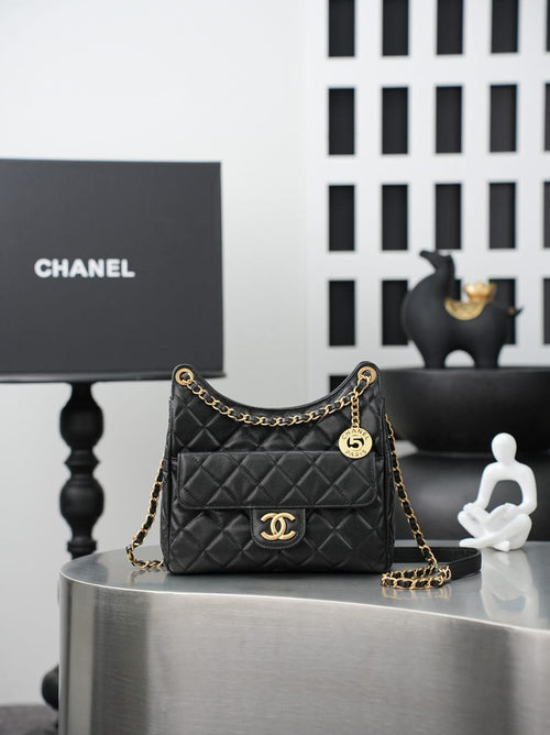 Chanel quilted shoulder bag in dark color with gold chain strap and CC logo front