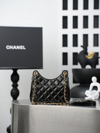Chanel quilted black mini bag on display with gold chain strap and CC hardware
