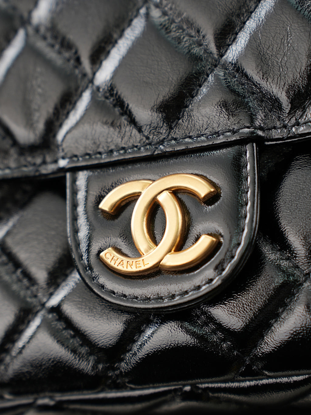 Chanel CC logo on quilted black leather flap with gold-tone hardware