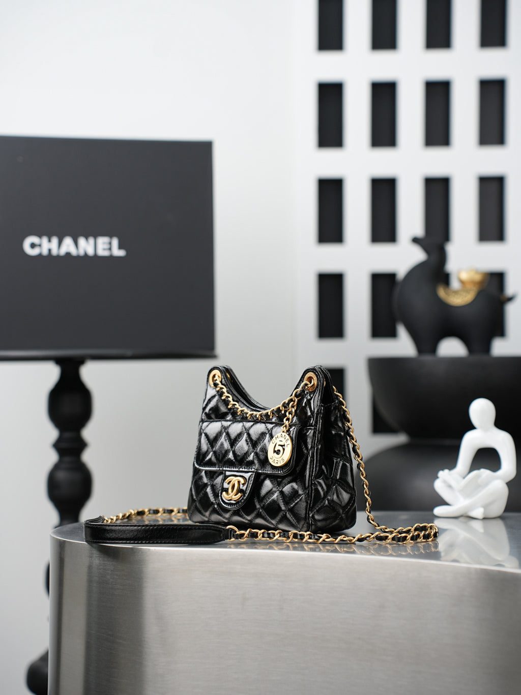 Chanel quilted black mini bag with gold chain shoulder strap and CC clasp