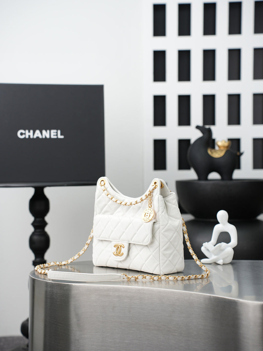 Chanel quilted mini shoulder bag in white with gold chain and front flap