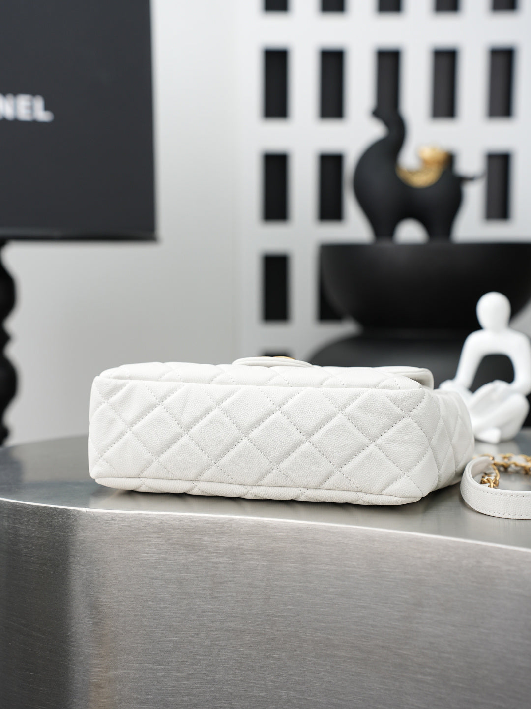 Chanel quilted white shoulder bag with braided gold chain strap and flat base