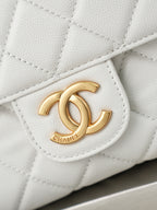 Chanel CC logo medallion on a white quilted flap with gold hardware