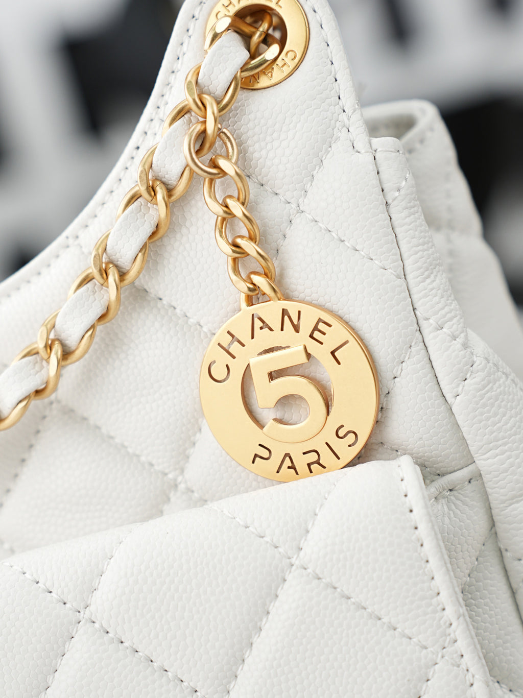 Chanel Paris 5 round charm on white leather strap with gold chain