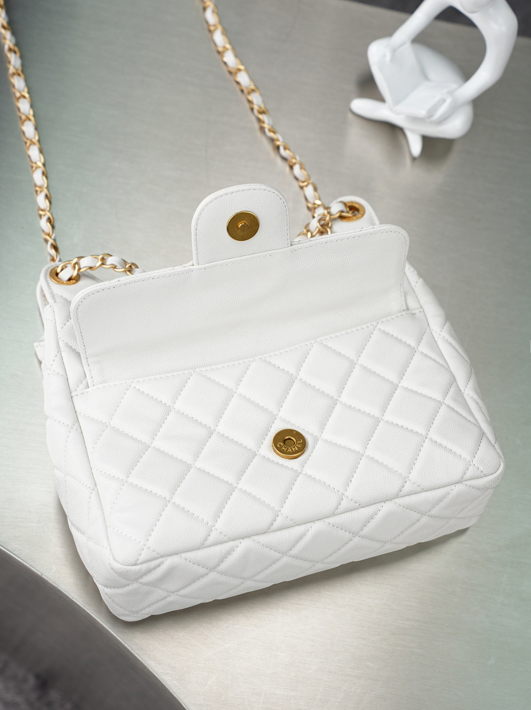 Chanel quilted white shoulder bag with gold clasp and long gold chain strap