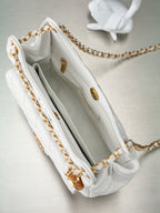 Chanel white shoulder bag interior with gray lining, pocket, and gold chain
