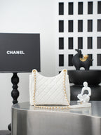 Chanel quilted shoulder bag in white with gold chain strap and top handle loops