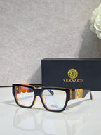 Versace eyeglasses with tortoise frames, clear lenses, and gold temple emblem